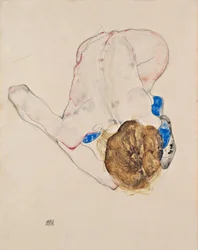 Nudo con calze blu, piegato in avanti